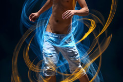 Photos of Handsome Shirtless Men Dancing with Light Rays,Colorful,in Motion.
