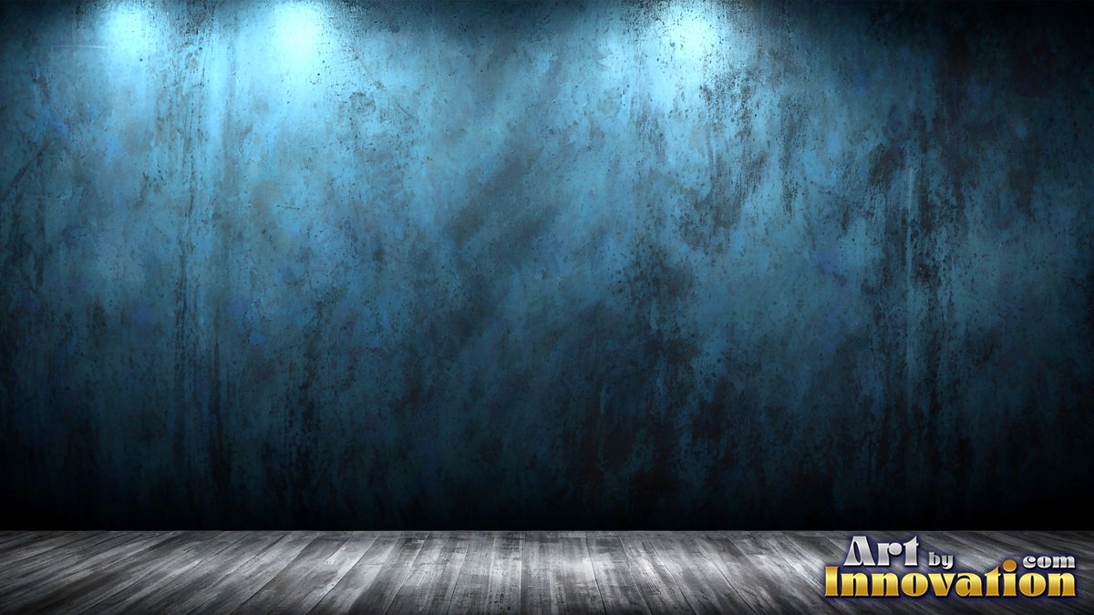 In an empty room, a dark blue textured wall stands over wooden floorboards