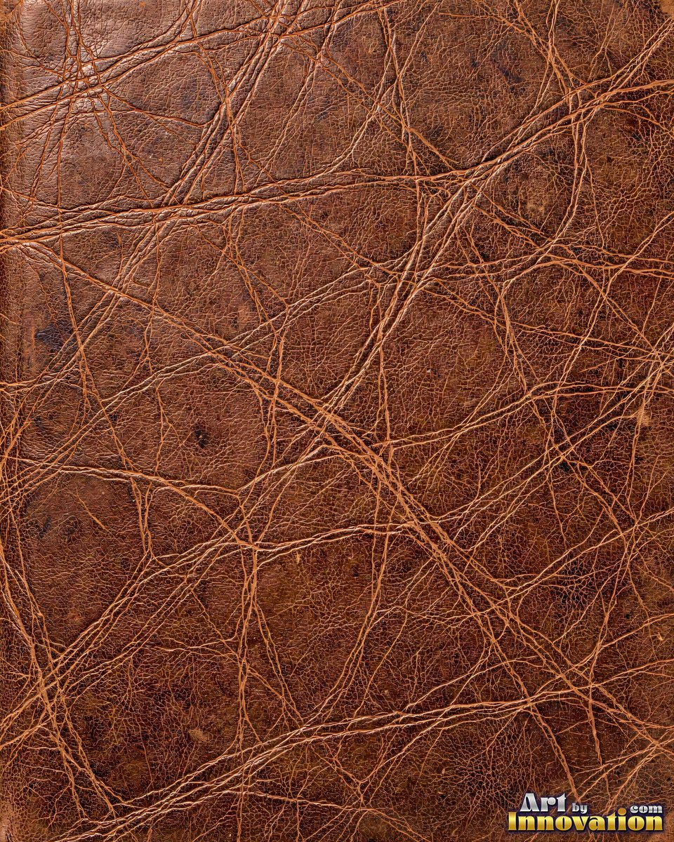 Old cracked leather with a crazed surface in whiskey brown