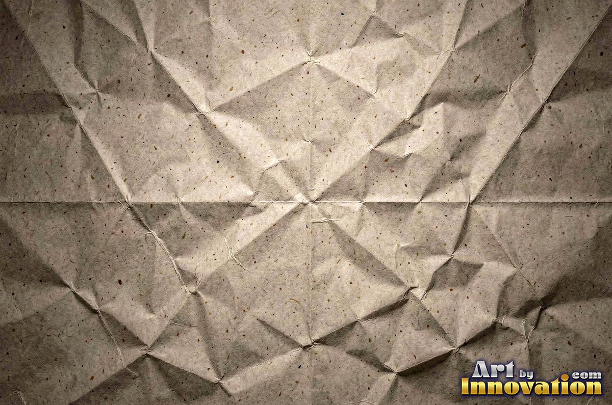 Crumpled paper smoothed out with a web of sharp creases in aged ivory