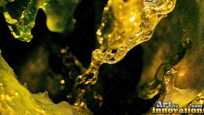 Splashing over a black backdrop, yellow fluid forms sculpted ripples and droplets