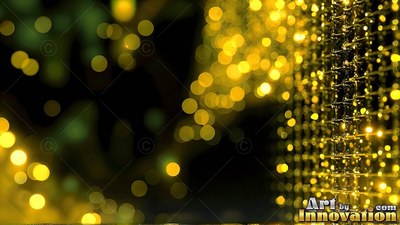 Hanging in darkness, a wire mesh reflects warm yellow fairy lights into blurry circles