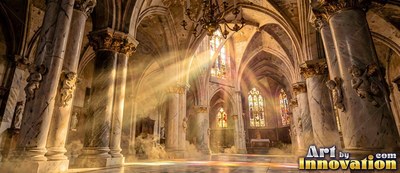 Streaming through mist, bright sunlight cuts across a cathedral with stone walls with marble pillars