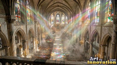 In a hazy stone cathedral, rainbow beams of light fall onto rows of pews