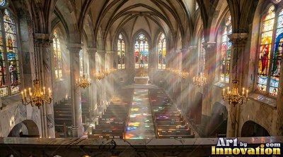 Tall marble columns line a vaulted cathedral where bright sunbeams cut across dark pews