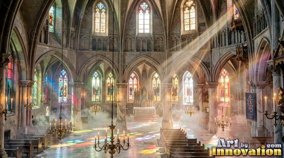 Arched stone windows let bright sunlight cut through haze inside a cathedral