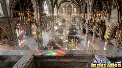 In a cathedral, colored light shines through smoke over empty pews