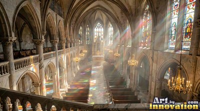 Looking down from a high balcony into a sunlit stone cathedral with pews