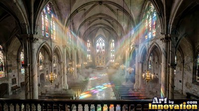 Cathedral nave with rainbow light beams cutting through misty air