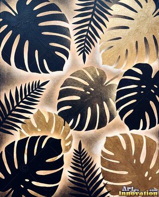 Black monstera leaves edged in gold with ferns glowing behind them