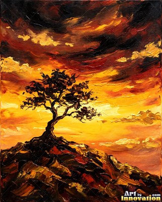 Lone tree silhouetted on a hilltop against a fiery sunset