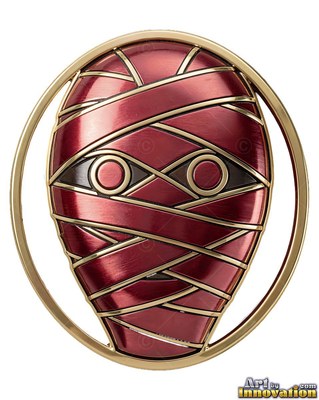 A metal mummy badge stares forward with polished red wraps bound by gold trim