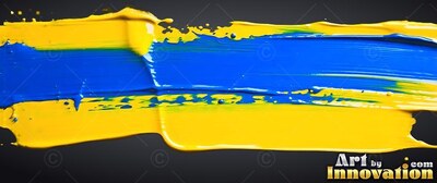 Thick yellow and glossy blue paint smeared across a black surface