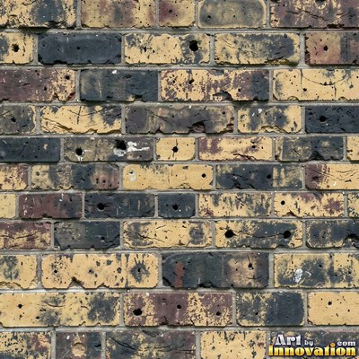 Painted charcoal brick with the paint worn off the edges, a full frame wall texture