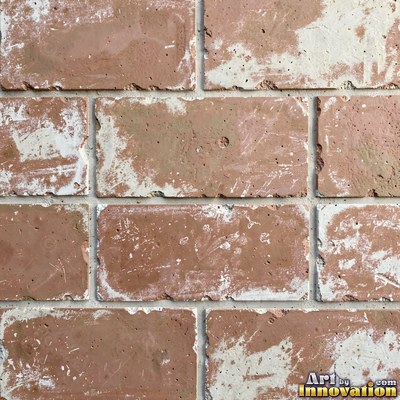 Charcoal glazed rectangular tiles laid in a herringbone pattern, flat front view