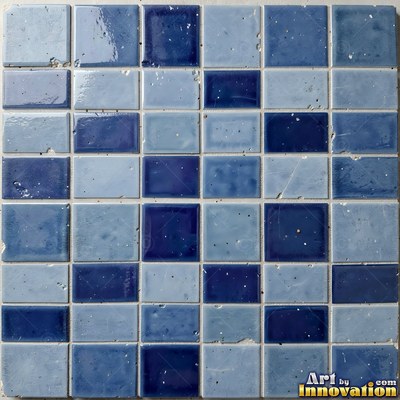 Old chipped yellow tiles with darkened grout lines filling the frame