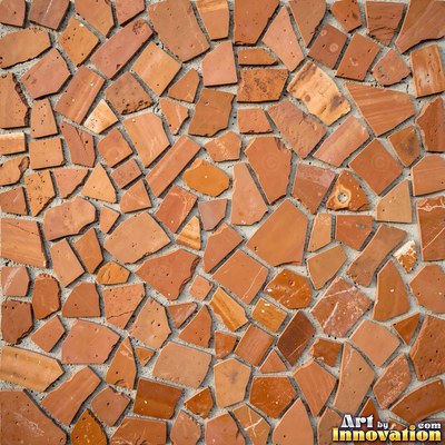 Broken tile mosaic of irregular yellow shards set in gray grout