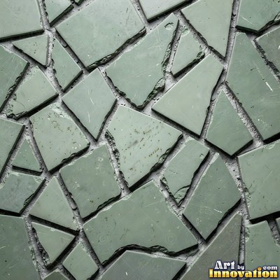 Broken tile mosaic of irregular yellow shards set in gray grout