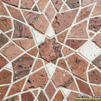 Broken tile mosaic of irregular yellow shards set in gray grout