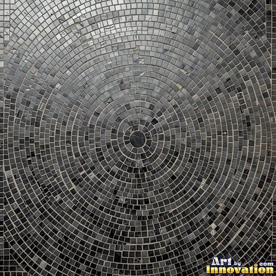 Broken tile mosaic of irregular yellow shards set in gray grout