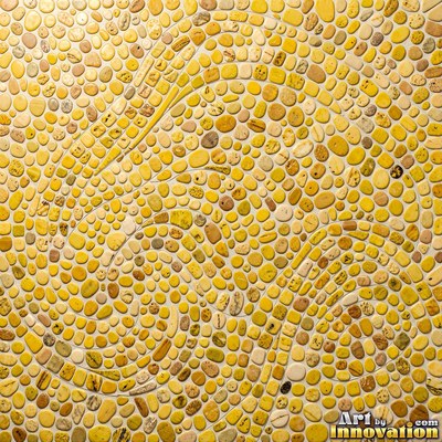 Broken tile mosaic of irregular yellow shards set in gray grout
