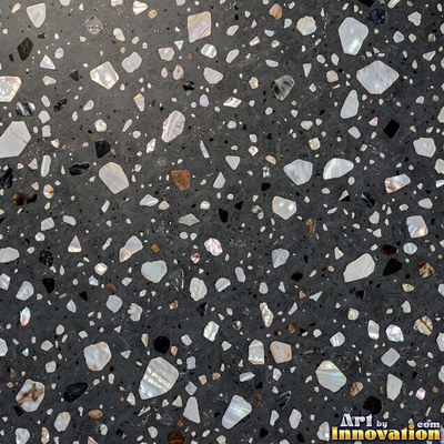 Polished terrazzo with small stone chips scattered evenly across a charcoal base