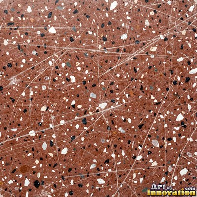 Polished terrazzo with small stone chips scattered evenly across a charcoal base