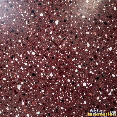 Polished terrazzo with small stone chips scattered evenly across a charcoal base