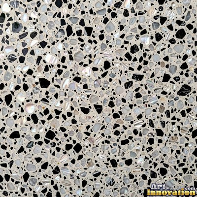 Minimal terrazzo with sparse chips on a smooth warm yellow base