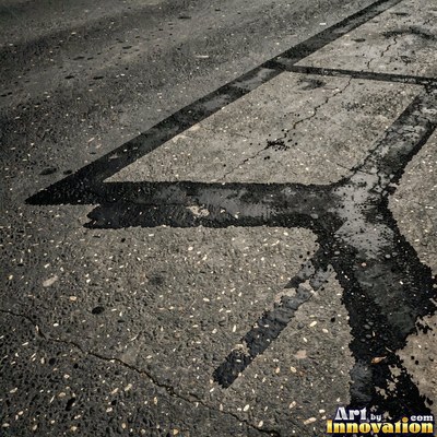 Worn asphalt with faded fragments of painted road lines