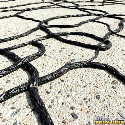 Worn asphalt with faded fragments of painted road lines
