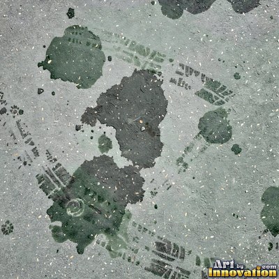 Asphalt pavement marked with oil stains and tire scuffs in medium gray