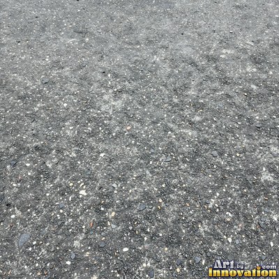 Worn asphalt with faded fragments of painted road lines