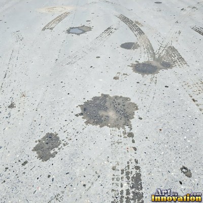 Fresh light gray asphalt with fine gravel texture, flat overhead view