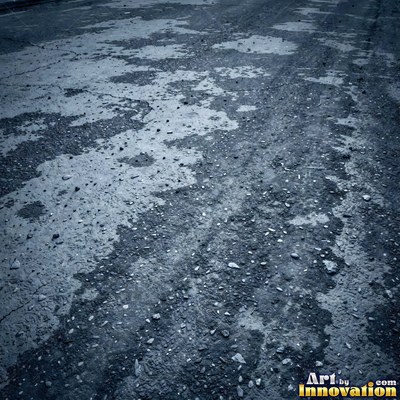 Wet asphalt glistening with small puddles in a greenish gray tone