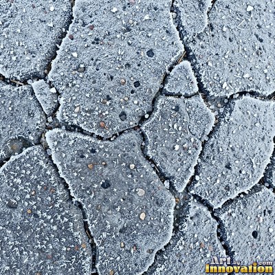 Worn asphalt with faded fragments of painted road lines