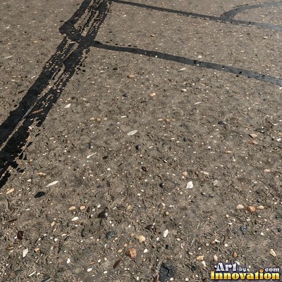 Worn asphalt with faded fragments of painted road lines