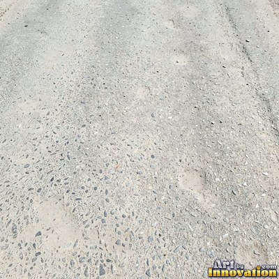 Fresh light gray asphalt with fine gravel texture, flat overhead view