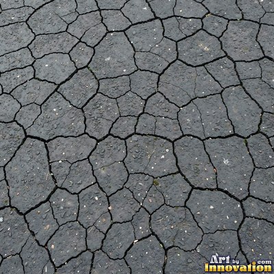 Worn asphalt with faded fragments of painted road lines