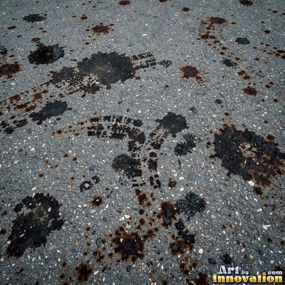 Worn asphalt with faded fragments of painted road lines