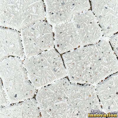 Wet asphalt glistening with small puddles in a greenish gray tone