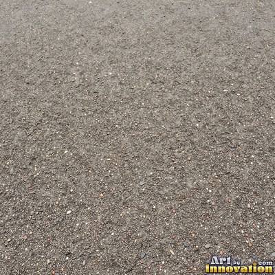 Worn asphalt with faded fragments of painted road lines