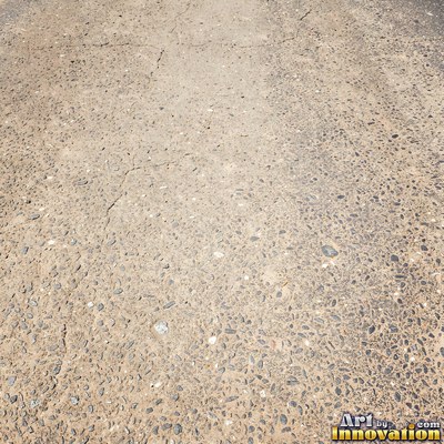Worn asphalt with faded fragments of painted road lines