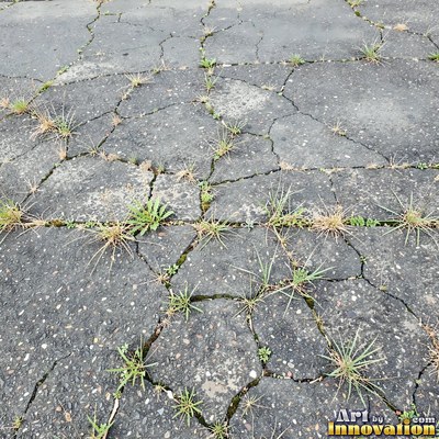 Worn asphalt with faded fragments of painted road lines