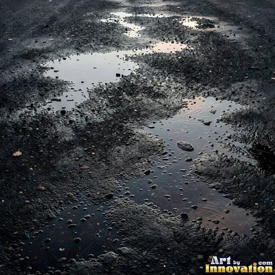 Worn asphalt with faded fragments of painted road lines
