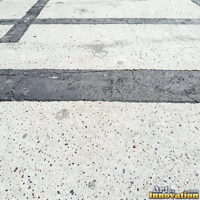 Fresh light gray asphalt with fine gravel texture, flat overhead view