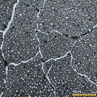 Worn asphalt with faded fragments of painted road lines