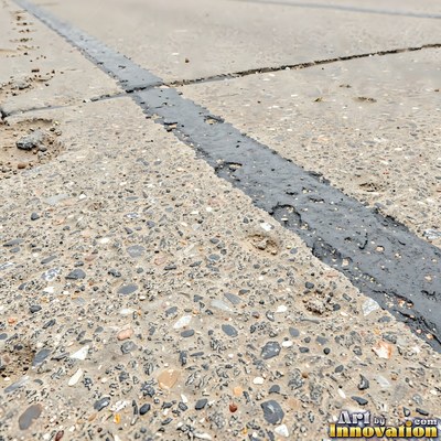Worn asphalt with faded fragments of painted road lines