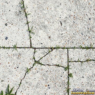 Asphalt pavement marked with oil stains and tire scuffs in medium gray