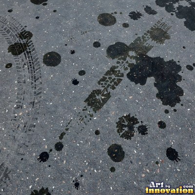 Asphalt pavement marked with oil stains and tire scuffs in medium gray